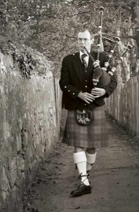 A member of The City of St Andrews Pipe Band can often be found “calling the boys home” as they play the day’s farewell from the stone streets of the city.